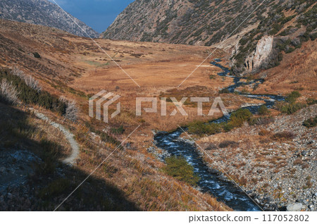 beautiful panorama landscape with river stream in an autumn orange valley in the mountains in fall beautiful panorama landscape with river stream in an autumn orange valley in the mountains in fall 117052802
