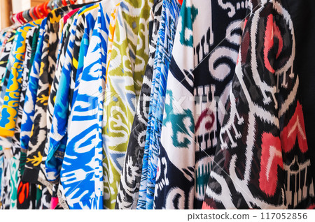 traditional indian dresses made of silk fabric with bright colorful pattern at oriental bazaar in India 117052856