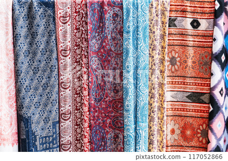 Traditional silk Indian scarves with a bright colorful pattern at an Asian bazaar in India close up 117052866
