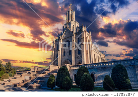 Cathedral of the Sacred Heart of Jesus in Tashkent in Uzbekistan. Exterior view of ancient Roman Catholic Church on background of cloudy beautiful sky in summer Cathedral of the Sacred Heart of Jesus in Tashkent in Uzbekistan. Exterior view of ancient Roman Catholic Church on background of cloudy beautiful sky in summer 117052877