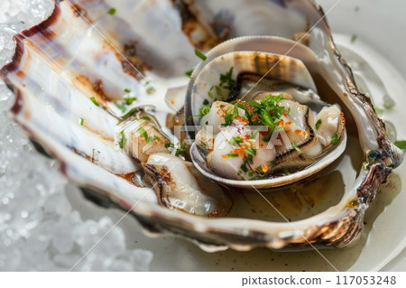 A shellfish dish with a garnish of parsley and a sprinkle of sesame seeds A shellfish dish with a garnish of parsley and a sprinkle of sesame seeds 117053248