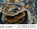 A cup of coffee is sitting on a wooden table with a pile of mushrooms on top of 117053352