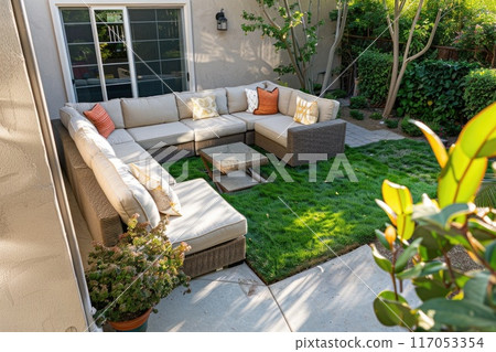 A patio with a couch and a table 117053354