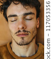 A man with a beard and mustache is sleeping 117053356