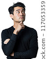 A man is standing with his arms crossed and looking to the right 117053359