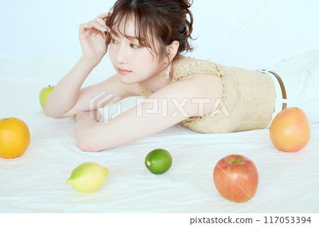 Portrait of a woman surrounded by fruit 117053394