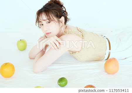 Portrait of a woman surrounded by fruit 117053411