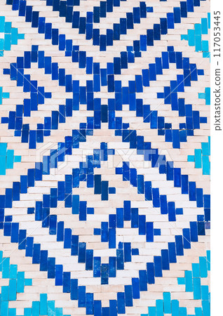 ancient ceramic tile with a traditional Asian pattern Uzbek ornament decorates wall of islamic Barakhan Madrasah in Tashkent, Uzbekistan 117053445