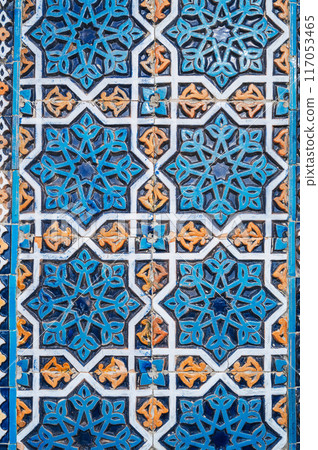 ancient ceramic tile with a traditional Arabic pattern Uzbek ornament decorates wall of old islamic Hazrati Imam mosque in Uzbekistan 117053465
