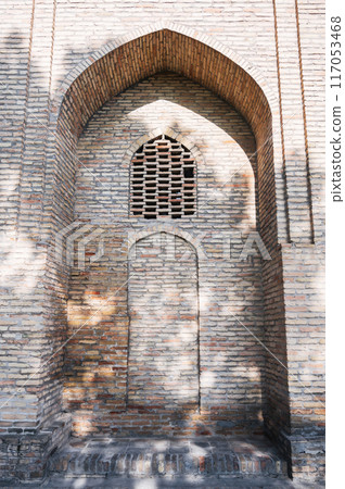 ancient door is bricked up on wall of old medieval Barakhan madrasah in Hazrati Imam complex in Tashkent 117053468
