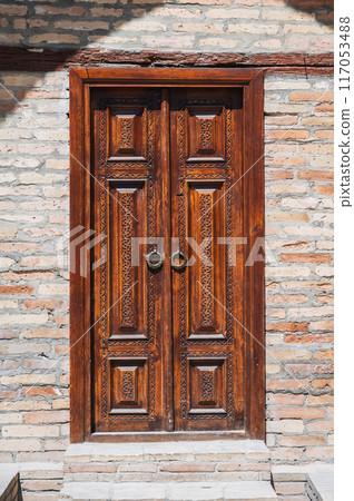 ancient carved wooden door with oriental Tajik carved pattern ornament in traditional Kandakori style 117053488