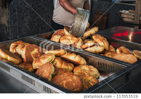 freshly baked traditional Central Asian tandoor flatbread on counter in the bakery. Traditional Uzbek bread in Uzbekistan 117053519
