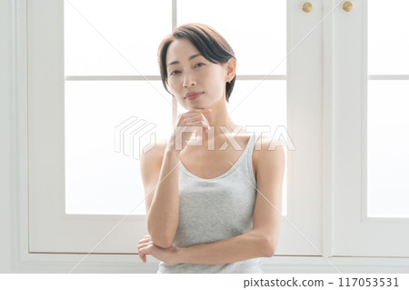 Middle-aged woman suffering from headache Middle-aged woman suffering from headache 117053531