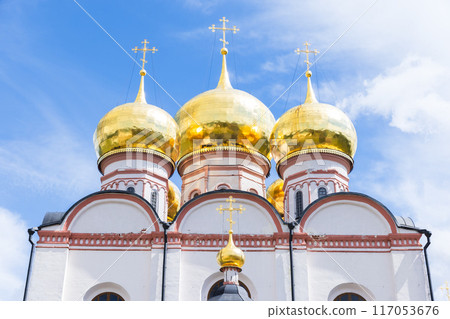 Golden domes with crosses are under blue cloudy sky 117053676