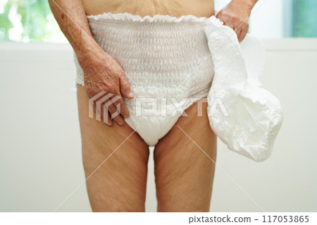 Asian senior woman patient wearing adult incontinence diaper pad in hospital. Asian senior woman patient wearing adult incontinence diaper pad in hospital. 117053865