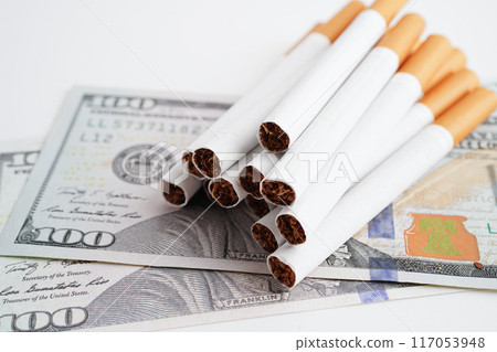 Cigarette on US dollar banknotes, cost, trading, marketing and production, No smoking concept. Cigarette on US dollar banknotes, cost, trading, marketing and production, No smoking concept. 117053948