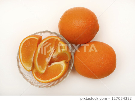 Sliced oranges on a white background. Chopped fruits. 117054352
