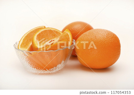 Sliced oranges on a white background. Chopped fruits. 117054353