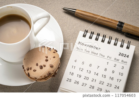 November 2024 - small spiral desktop calendar with a stylish pen and a cup of coffee, time and business concept November 2024 - small spiral desktop calendar with a stylish pen and a cup of coffee, time and business concept 117054603
