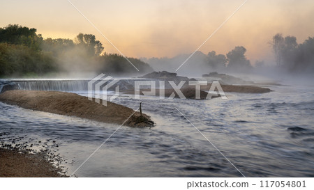 Mornig fog over a river diversion dam 117054801