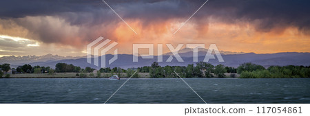 dramatic, stormy sunset with high wind over Longs Peak and Front Range of Rocky Mountains in northern Colorado 117054861