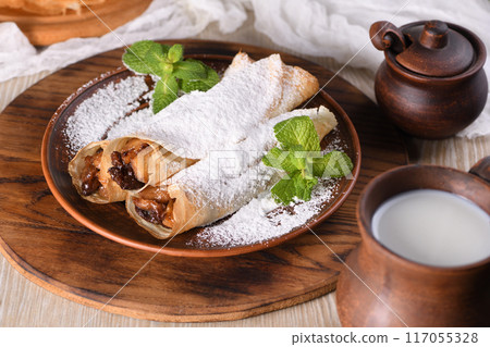 Homemade thin crepe (pancakes) with apple filling 117055328