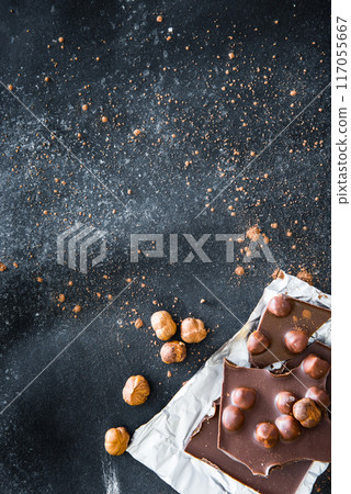 Chocolate and nuts on black table Chocolate and nuts on black table 117055667