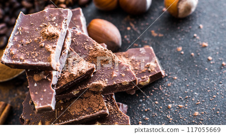 Chocolate and nuts on a black table 117055669