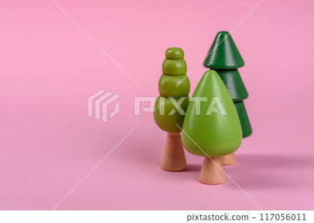 Wooden model of a tree with a green crown and trunk on a pink background Wooden model of a tree with a green crown and trunk on a pink background 117056011