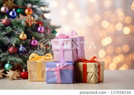 Beautifully wrapped gifts under a decorated Christmas tree with colorful ornaments 117056538