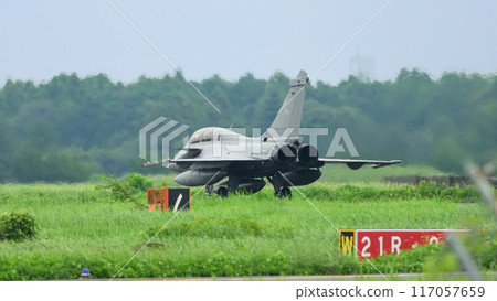 A French Aerospace Forces Rafale B fighter plane taxiing. 117057659
