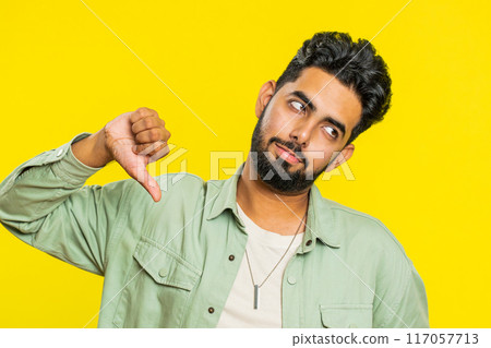 Upset man guy showing thumbs down gesture disapproval dissatisfied dislike negative feedback Upset man guy showing thumbs down gesture disapproval dissatisfied dislike negative feedback 117057713