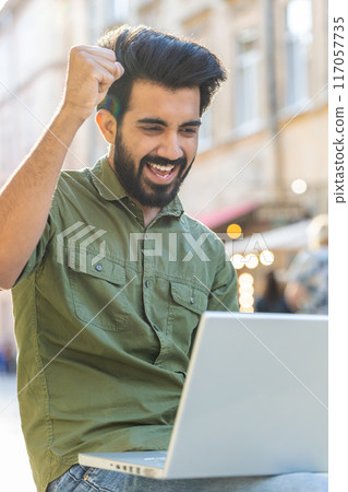 Happy indian man use laptop celebrating success, win message, playing game, lottery jackpot victory Happy indian man use laptop celebrating success, win message, playing game, lottery jackpot victory 117057735