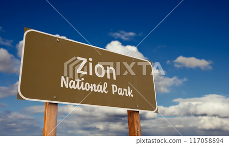Zion National Park (Utah) Road Sign Against Blue Sky and Clouds. 117058894