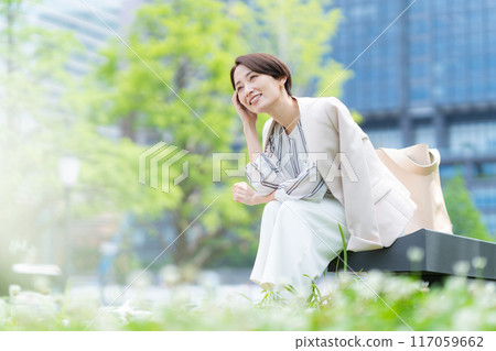Middle-aged business woman working in an office district Middle-aged business woman working in an office district 117059662