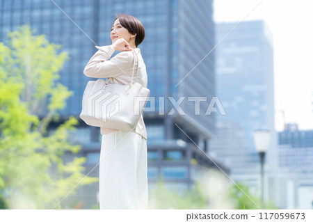 Middle-aged business woman working in an office district Middle-aged business woman working in an office district 117059673