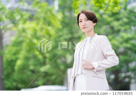 Middle-aged business woman working in an office district Middle-aged business woman working in an office district 117059685