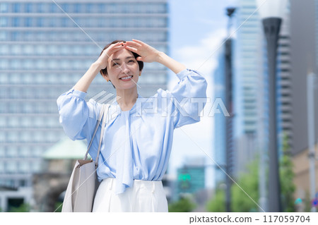 Middle-aged business woman working in an office district 117059704