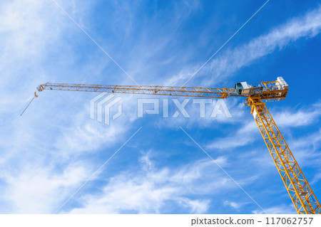 Tower crane working in construction site and stand out from the cloudy bright blue sky Tower crane working in construction site and stand out from the cloudy bright blue sky 117062757