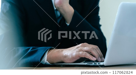 Businessman worried while looking at a computer 117062824