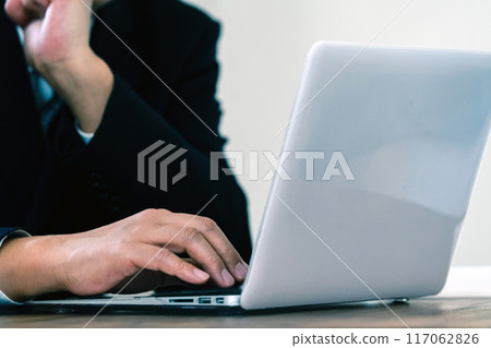 Businessman worried while looking at a computer 117062826