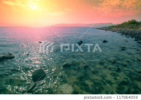 Rocky shore of the Sea of Galilee at sunrise 117064059