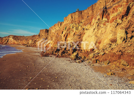 Seascape on a sunny day. Clay steep coast. Seashore in summer Seascape on a sunny day. Clay steep coast. Seashore in summer 117064343