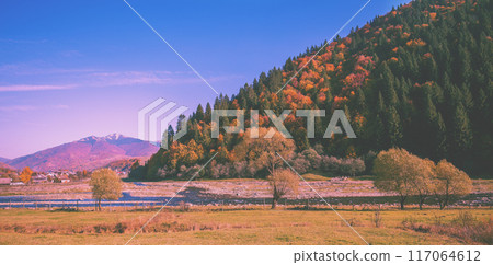 View of mountains and river in autumn during sunrise. View from the car. Horizontal banner View of mountains and river in autumn during sunrise. View from the car. Horizontal banner 117064612