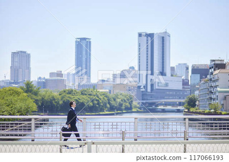 穿著西裝的年輕商人在商業區行走 117066193