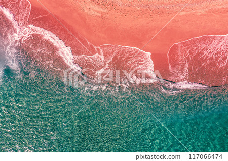 Sandy sea coast. Sea surf on the sandy beach. View from above. Artistic red-green color. gradient color Sandy sea coast. Sea surf on the sandy beach. View from above. Artistic red-green color. gradient color 117066474