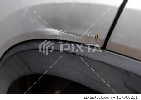 Minor scratches and dent on the body of a car due to accident. Minor scratches and dent on the body of a car due to accident. 117068211