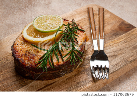 salmon steak, fried, on a cutting board, top view, rosemary, lemon and lime, homemade, one serving, no people, salmon steak, fried, on a cutting board, top view, rosemary, lemon and lime, homemade, one serving, no people, 117068679