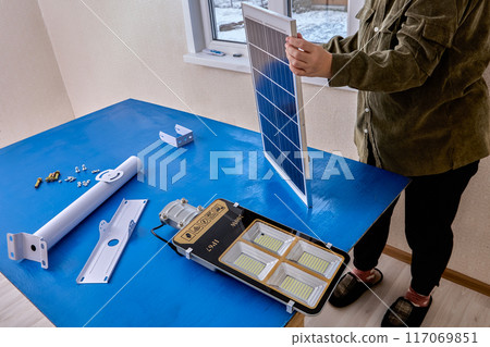 Solar lighting mounting table, installer will fix LED lamp and solar panel on bracket. Solar lighting mounting table, installer will fix LED lamp and solar panel on bracket. 117069851