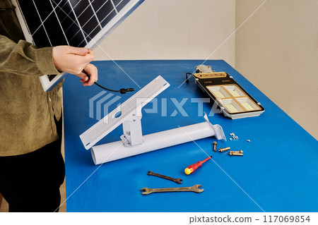 Solar panel holder on mounting bracket for LED street light, DIY assembly at home. Solar panel holder on mounting bracket for LED street light, DIY assembly at home. 117069854